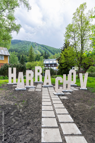 Harrachov sign with Certova hora mountain in background, Czechia
