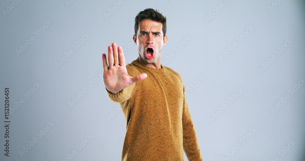 Naklejka premium Warning, stop and portrait of man in studio for rejection, deny or no hand gesture for protest. Shout, serious and male person with palm for caution, safety or self defense by gray background.