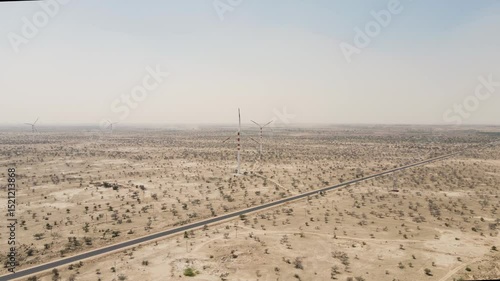 Wallpaper Mural Aerial drone shot flying above a line of windmills cutting through the vast Thar Desert. Torontodigital.ca