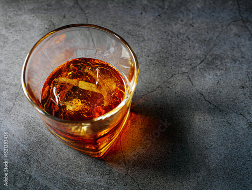 Strong alcohol drink. Whisky in glass with ice, Whisky, bourbon or cognac. Hard strong alcoholic drink