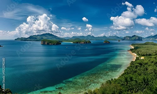 Wallpaper Mural Aerial view of a tropical seascape with turquoise waters, lush green islands, and a clear blue sky scattered with clouds. Torontodigital.ca