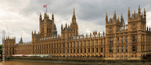 Panoramic View of Houses of Parliament on the River Thames with Union Jack Flag flying proudly. It has recently been renovated and is looking fresh and clean