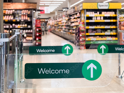 entry to a supermarket with welcome signs and arrows
