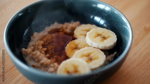 Wallpaper Mural Steaming hot porridge with banana slices in a ceramic bowl on wooden table Torontodigital.ca