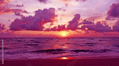 Beautiful sunset beach on magenta pink sky n dramatic red purple cloud or rain storm cloudscape over sea water horizon n calm ocean wave in tropical summer sunlight or sun ray, 4k nature background