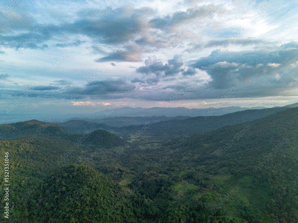 Fototapeta premium High-angle view of green mountain area and traces of agriculture in a northern community in Chiang Mai, Thailand. Beautiful mountain and sky.