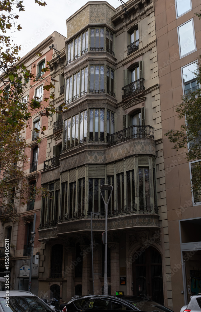 Fototapeta premium Art Nouveau building facade in Barcelona, Spain. Interesting Art Nouveau Architecture Buildings facade in Barcelona, Spain. (Arquitectura modernista). These fancy buildings date for the most from the 