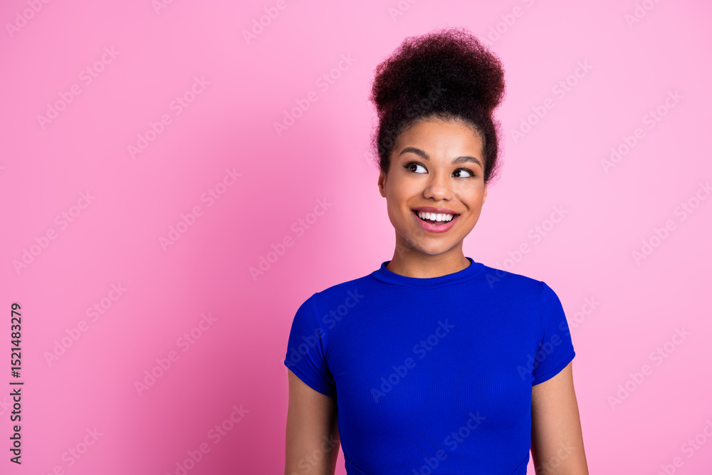 Charming young woman with curly hairstyle poses against pink background wearing blue making happy and cheerful expression Charming young woman with curly hairstyle poses against pink background wearing blue making happy and cheerful expression