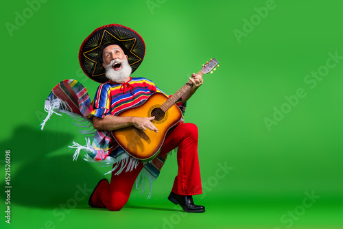 Elderly man in colorful Mexican attire strumming a guitar against a vibrant green backdrop conveying joy and cultural celebration