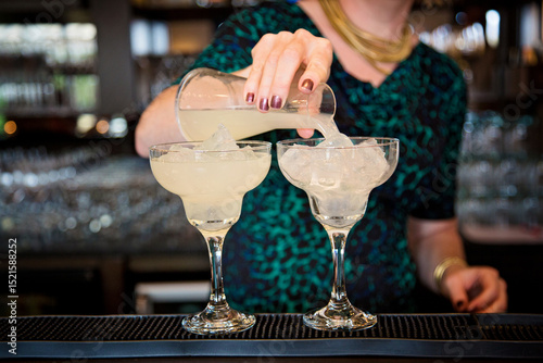 woman bartender in the bar preparing drink
