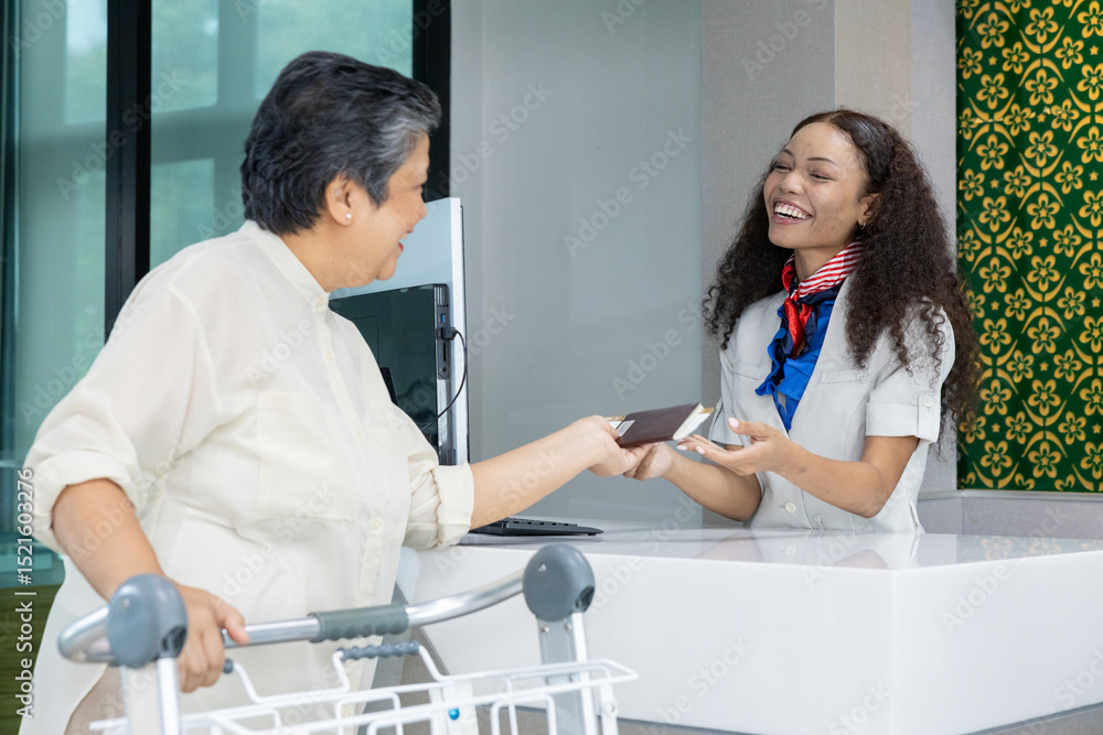 Obraz premium Passengers queuing at airport check-in counter