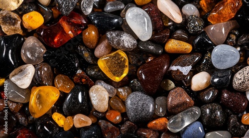 Colorful Collection of Polished Stones Displayed on a Natural Surface in Brig...