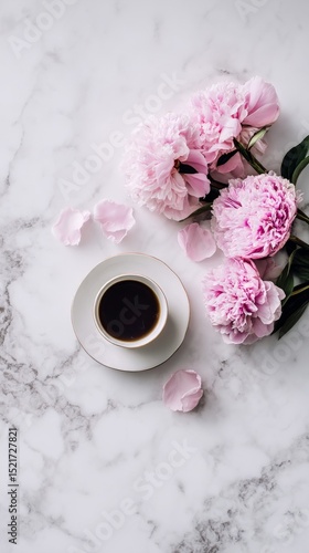 Coffee Cup Beside Pink Peonies on Marble Surface in a Bright Setting During D...