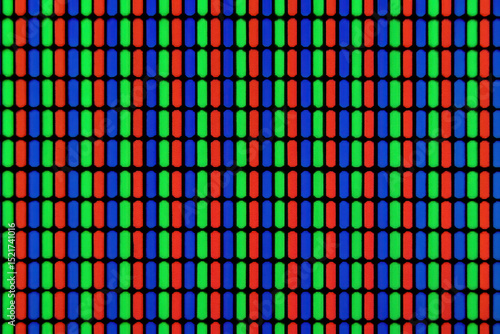 Close up view of colorful RGB pixel pattern on screen, showing red, green, and blue subpixels in repetitive grid. vibrant display highlights intricate design of digital screens