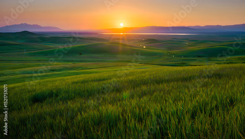 Dramatic mountain landscape at sunrise or sunset, featuring a panoramic view of misty hills and cloud-kissed peaks under a vibrant sky