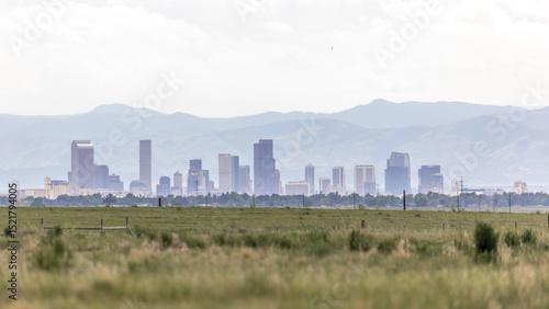 From Commerce City, the distant Denver skyline rises against the backdrop of Colorado’s wide plains and hazy blue sky.
