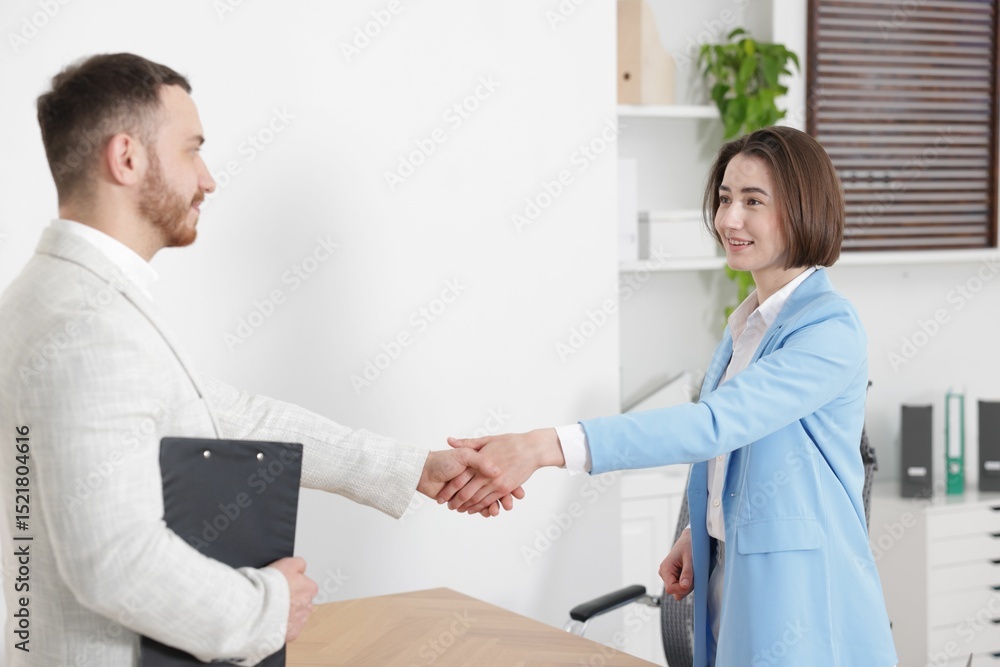 Fototapeta premium Recruiter and candidate shaking hands in office