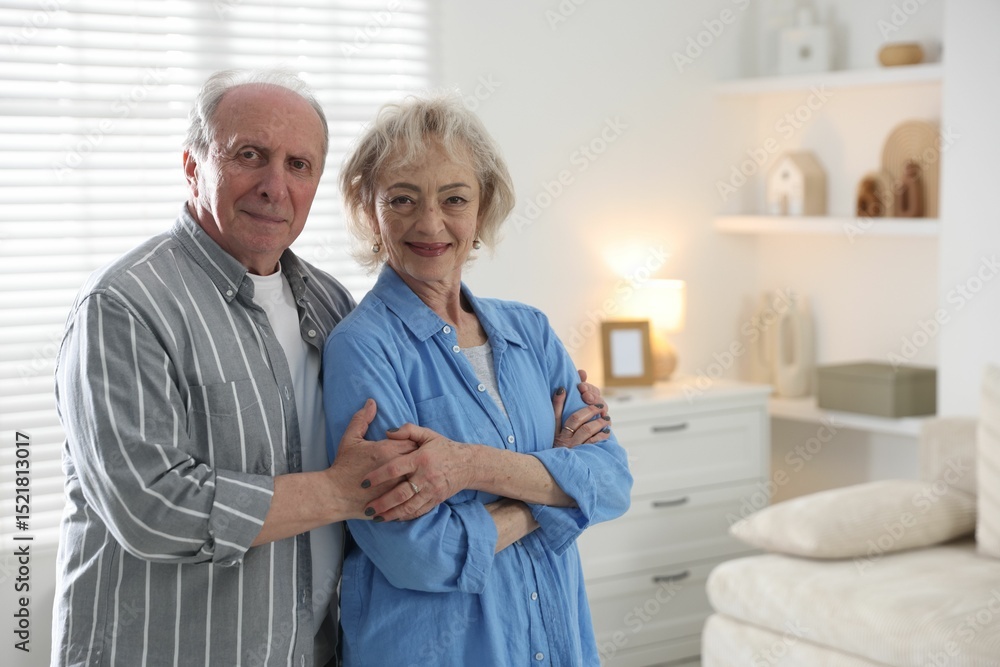 Obraz premium Lovely senior couple at home, space for text