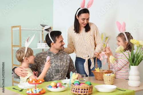 Male soldier with his famil...