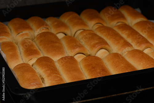 фотографія Golden homemade Parker House rolls baking in the oven