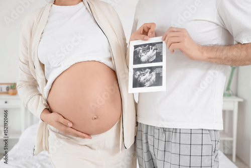 Happy pregnant couple with ...