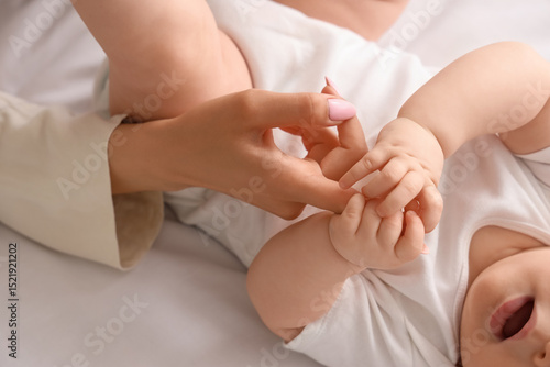 Little baby holding mother'...