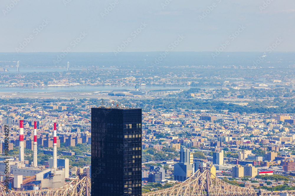 Fototapeta premium Distant view of New York City skyscrapers, power plant and Verrazzano Bridge in smog. New York. USA.