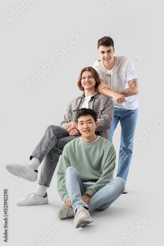 Group of young men on light...