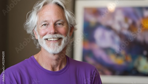 Smiling man wearing a purple shirt.