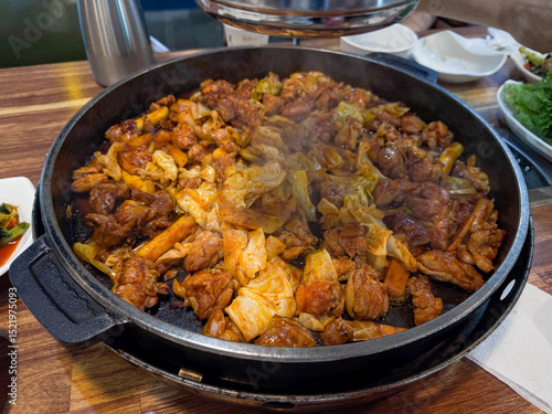 Dakgalbi, cooking on a hot plate, close-up, Korean chicken dish