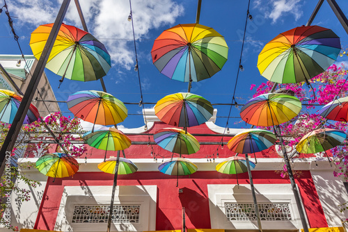 Fotografie Street with a rainbow parasol in the Dominican Republic