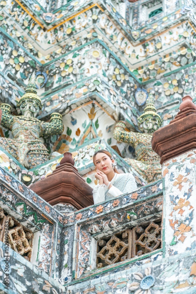 Fototapeta premium Young Woman in Traditional Thai Dress at Wat Arun, Temple of the Dawn, Bangkok, Thailand