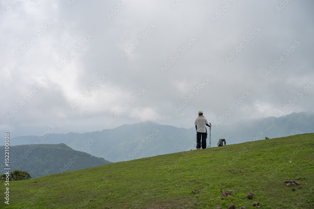 Fototapeta premium The woman standing alone on a mountaintop