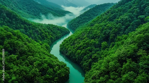 A winding river flows between verdant forested mountain slopes