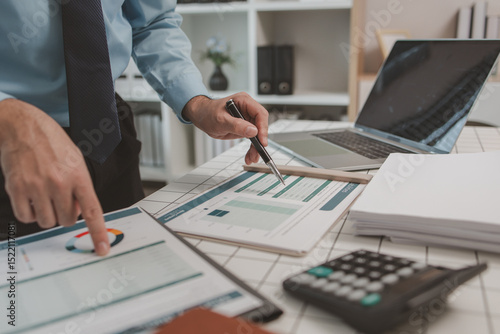 фотографія the chief accountant is working hard to check the documents and financial figure