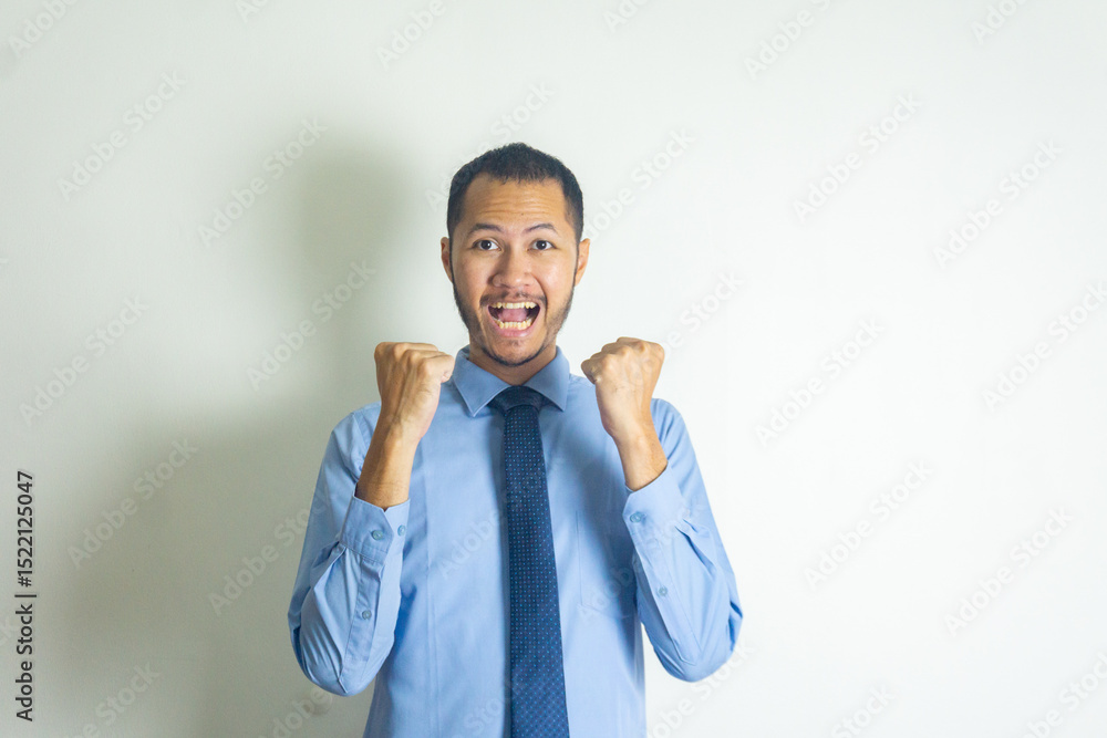 Fototapeta premium Businessman winning gesture with necktie and smilling