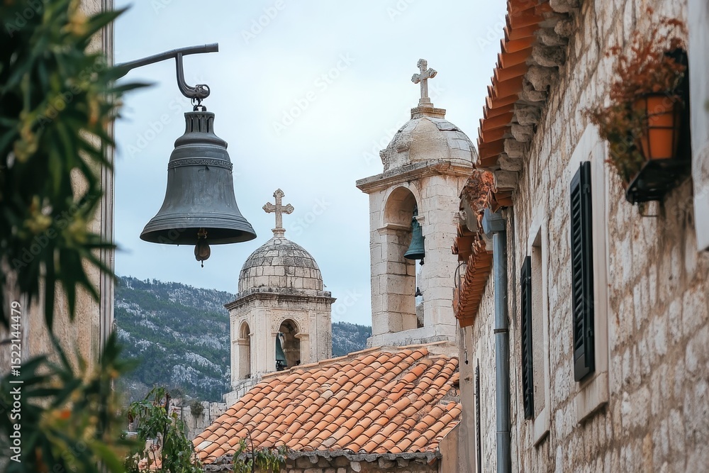 Obraz premium Church bells ringing in the Jewish Quarter of a historic town surrounded by mountains, Church bells and houses in Jewish Quarter