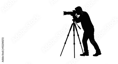 Photographer taking pictures with camera on tripod in silhouette  