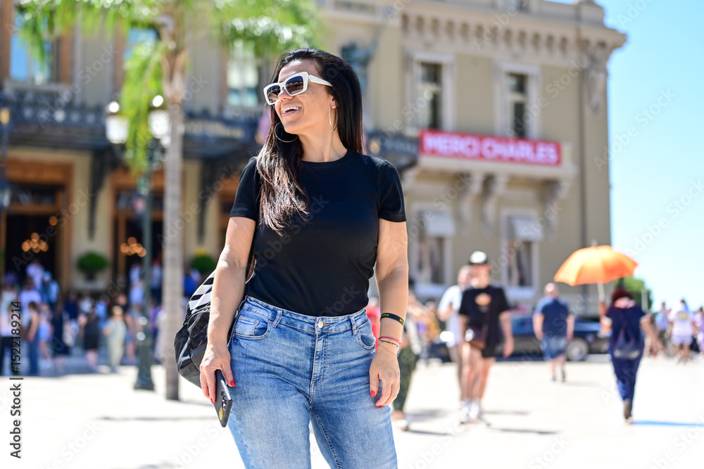 Fototapeta premium Portrait of happy smiling woman at Monaco . Casual portrait outdoors, tourist in Monte Carlo Brunette woman near the Casino of Monte Carlo
