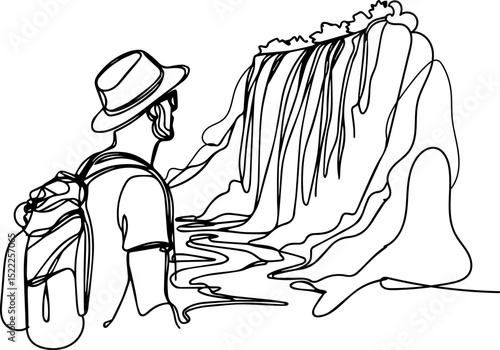 Man admiring waterfall while hiking in scenic landscape  