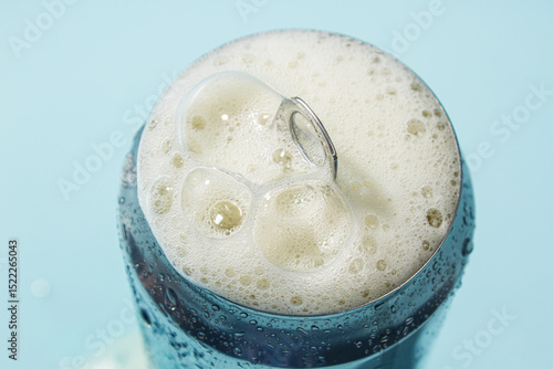 Open aluminum can with foam close up. Cold refreshing drink