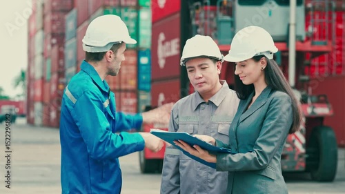 Industrial engineer working at shipping container yard with woman manager and diverse workers inspecting cargo loading. Logistics team checking import export shipment at terminal dock.