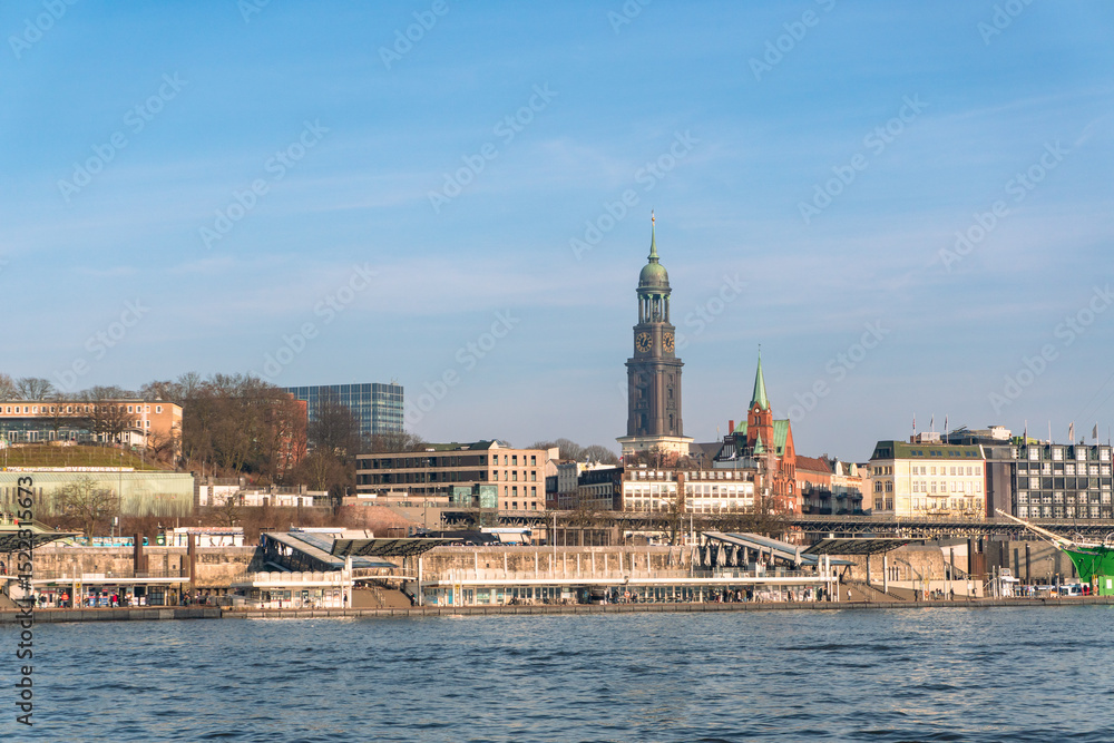 Fototapeta premium Landungsbrücken and St. Michaelis Church in Hamburg, Germany on a sunny day