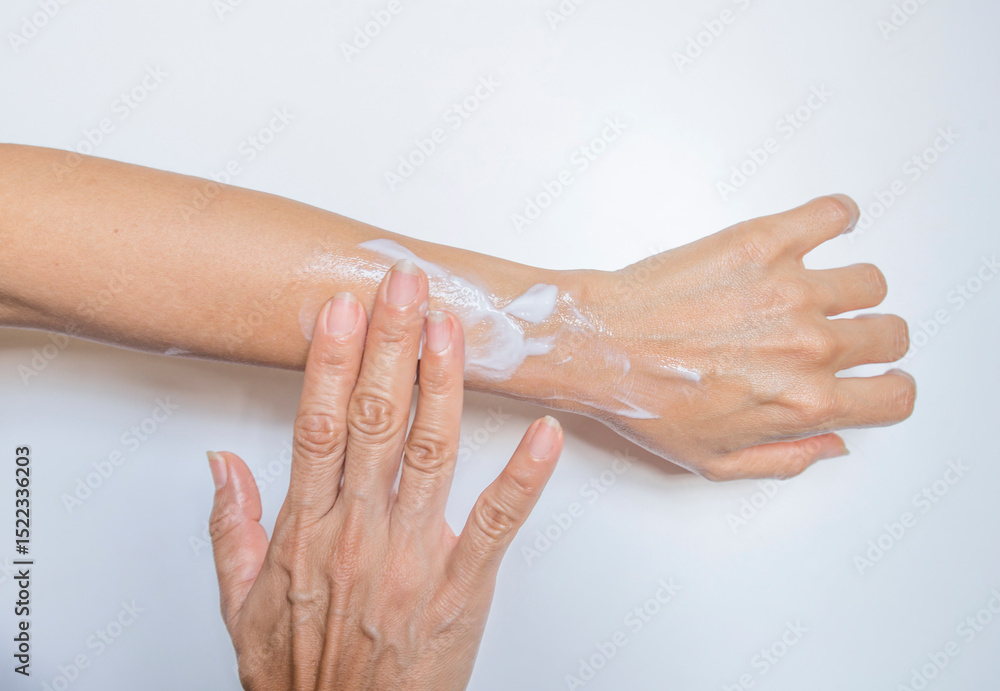 Fototapeta premium Woman applying moisturizing cream on her hands. Skin care concept.