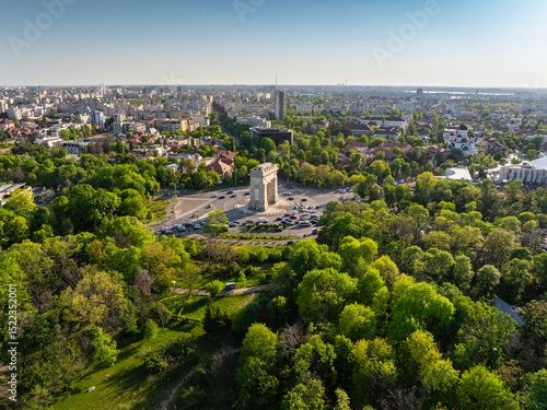 Aerial Bucharest. Arch of Triumph, Kiseleff boulevard and Herastrau Park in an aerial photo taken in the north part of Bucharest, Romania, during a summer day. Bucharest from above.