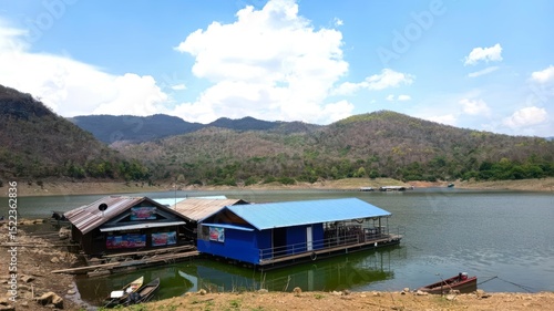 Scenic Lakeside Houses with Mountains and Clear Blue Sky View