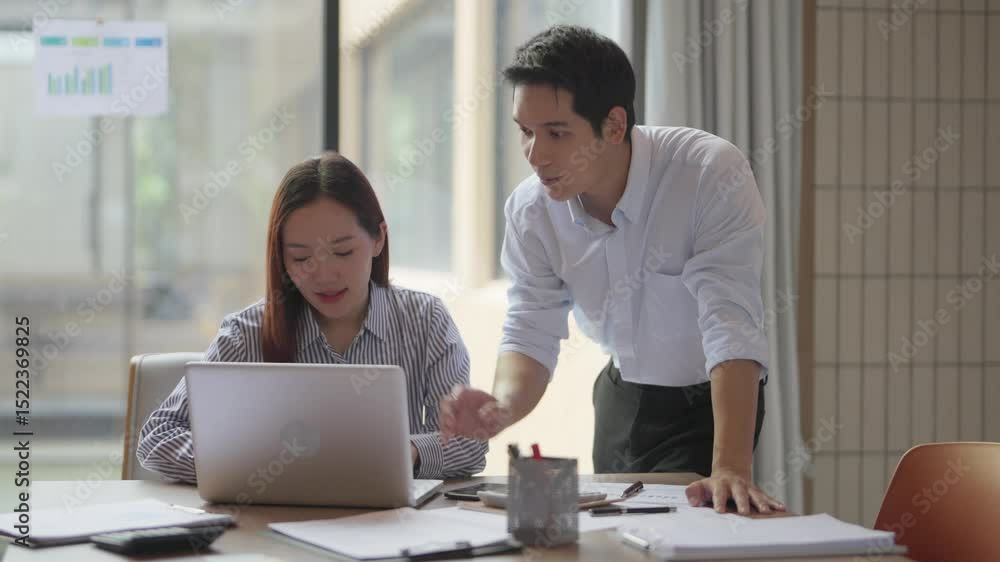 Asian mentor and supervisor working together to support training of office trainee in business strategy Asian mentor and supervisor working together to support training of office trainee in business strategy