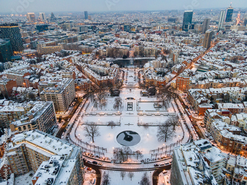 Aerial view of  a snow covered Ambiorix Park in Central Brussels on a winter morning with street lights