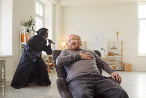 Senior man sitting at armchair, clutching chest in pain while grim reaper with scythe sneaking behind. Alone male pensioner experiencing heart attack or infarct at home, feeling closeness of death.