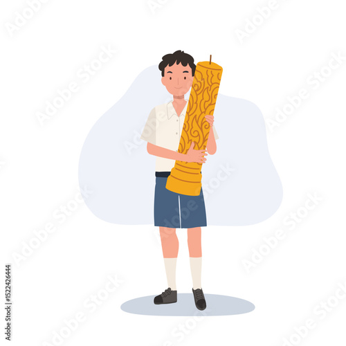 thai schoolboy holding large wax candle for buddhist holiday celebration in thailand cultural festival and asian tradition.